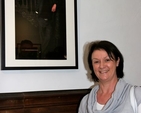 Denise Pierpoint poses beside a photograph of her husband, Archdeacon David Pierpoint, at the opening of the inaugural exhibition, ‘Reflections’, in the new St Michan’s community art gallery. 