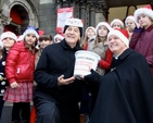 Archbishop Michael Jackson and Canon David Gillespie with members of Taney Parish Junior Choir at the launch of the 2014 Black Santa Sit Out at St Ann’s, Dawson Street. 