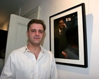 Gavin Elliot poses beside his portrait which forms part of the exhibtion ‘Reflections’ by Maeve McCarthy and Mella Travers, which is the first to take place in the new St Michan’s community art gallery. 