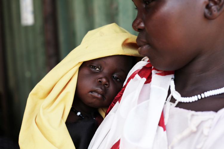A mother with her 12–month old daughter who has been diagnosed with severe acute malnutrition. Photograph courtesy of Andeea Campeanu/Christian Aid.