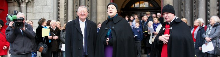 Archbishop Diarmuid Martin, Archbishop Michael Jackson and the Revd David Gillespie with the Seafield Singers and children of the Catholic University School collecting for Black Santa Appeal
