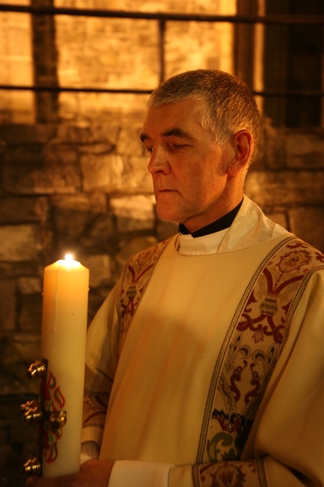 The Archdeacon of Dublin, the Venerable David Pierpoint with the Paschal Candle lit during Easter Vigil in Christ Church Cathedral.