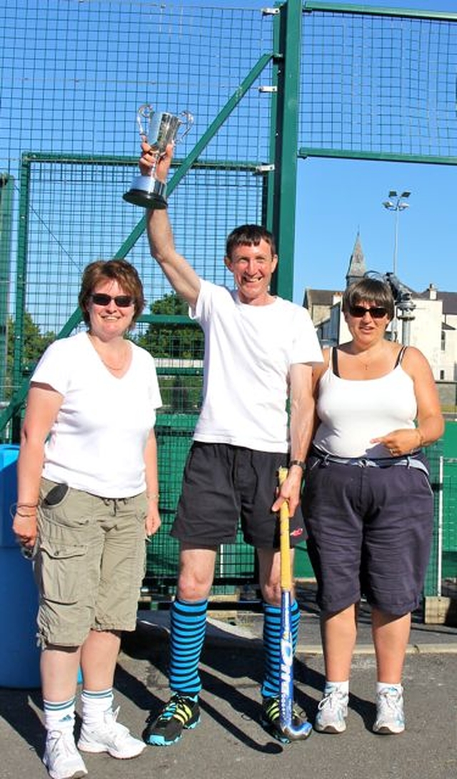 Graham Codd accepts the trophy on behalf of the victorious team from Newcastle and Newtownmountkennedy with Calary at the Diocesan Inter Parish Hockey Tournament in St Andrew’s College, Dublin, on June 9.