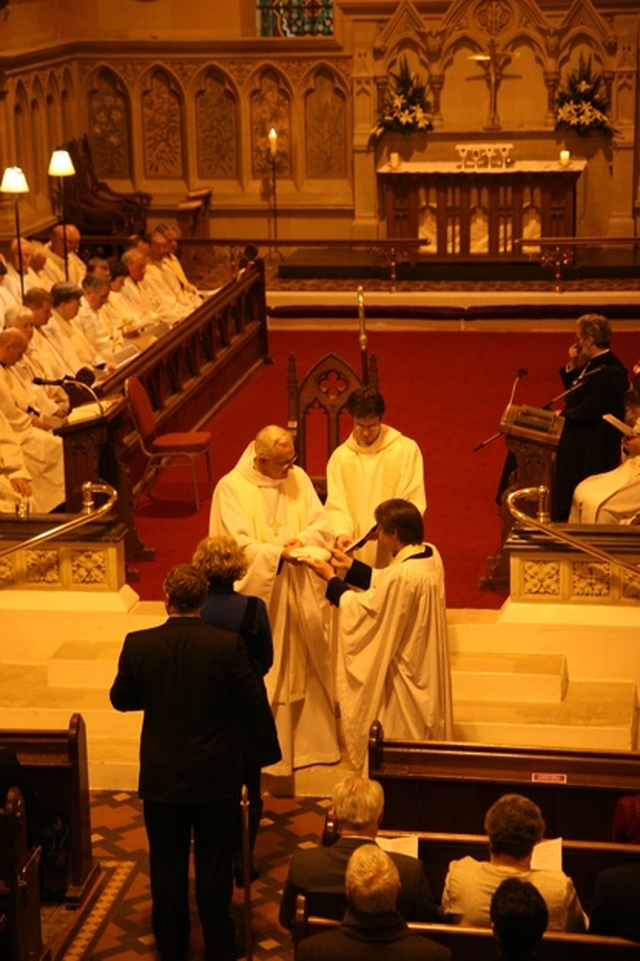 The Archbishop of Dublin, the Most Revd Dr John Neill presents the Revd Canon Patrick Lawrence with a stole, one of the symbols of his ministry at his institution as the new Rector of Monkstown.