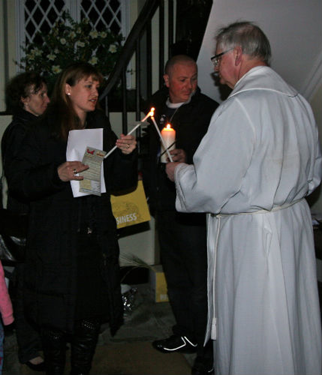 Members of the congregation light their candles as they enter Killiskey Parish Church for the Easter Vigil. 