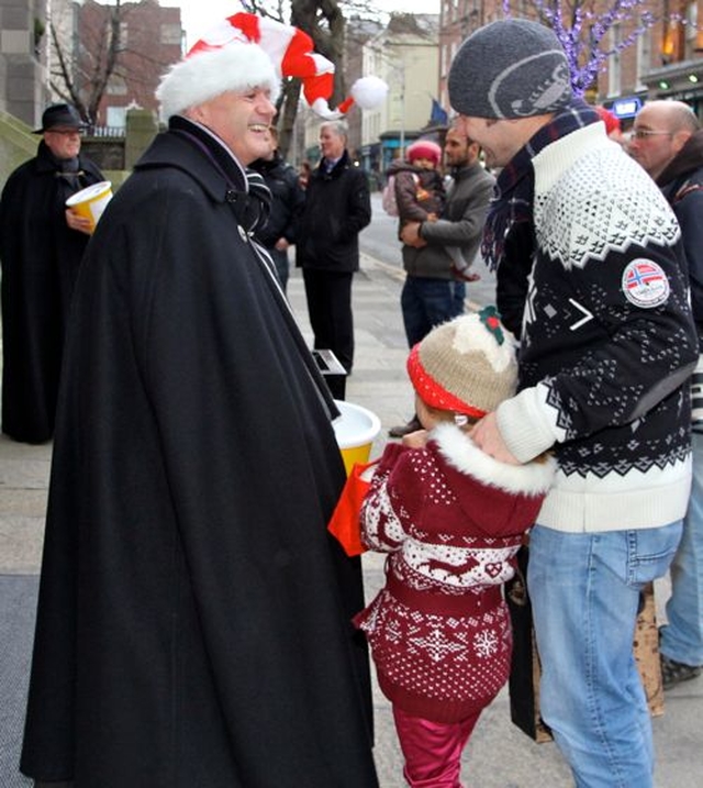 Vicar of St Ann’s, the Revd David Gillespie, collects for the Black Santa charities at the launch of the annual sit out today, December 18. 