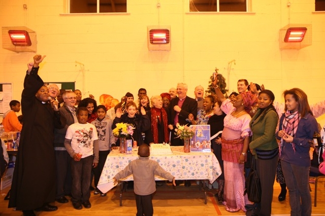 The Diocesan Chaplain to the International Community, the Revd Obinna Ulogwara (left) leads the singing of Happy Birthday to the Archbishop at the reception following the Discovery Advent Service in St Maelruain's Church, Tallaght. 