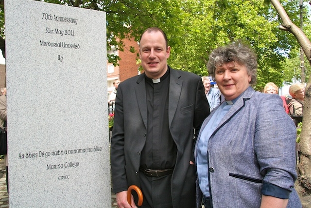 The Revd Roy Byrne, Rector of Drumcondra and North Strand parish, and the Revd Aisling Shine, Curate-Assistant in the parish, beside the North Strand Bombing commemorative plaque in the Memorial Garden at Marino College of Further Education. 