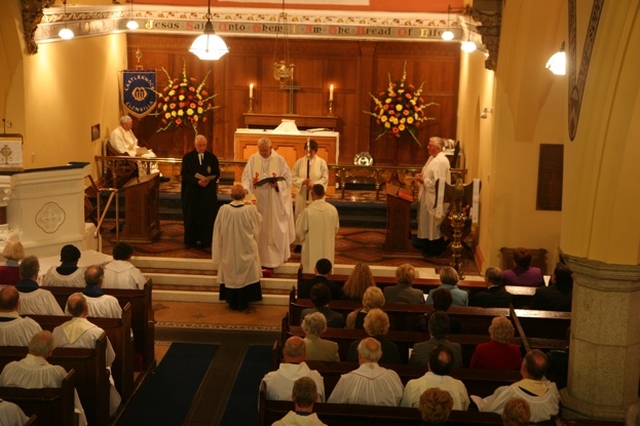 The Archbishop of Dublin, the Most Revd Dr John Neill presents the Act of Institution to the new Rector of Castleknock and Mulhuddart with Clonsilla, the Revd Paul Houston as his institution. 