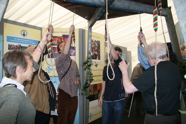 Ringing the bells at the churches' joint stall.