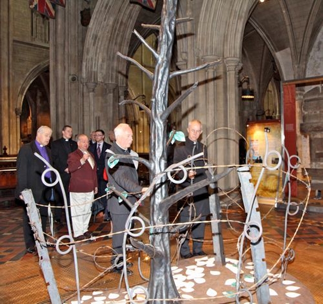 Archbishop Justin Welby examines the Tree of Remembrance in the Lives Remembered Exhibition at St Patrick’s Cathedral during the Dublin leg of his visit to the Church of Ireland. Also pictured is Dean Victor Stacey. 