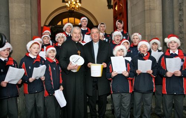 Archbishop Michael Jackson and Archbishop Diarmuid Martin with the choir of the Catholic University School at the Black Santa Sit Out at St Ann’s Church, Dawson Street, on Thursday December 20. An estimated €15,000 had been collected for charity in the first four days of the appeal which continues until Christmas Eve. 