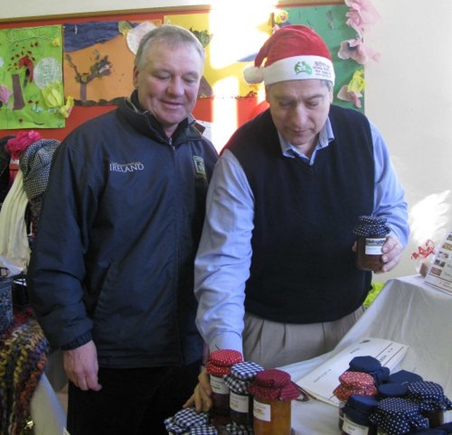 Colin Boyle and Gareth Hickey discuss the qualities of some jam at the recent Sandford Parish Christmas Bazaar.
