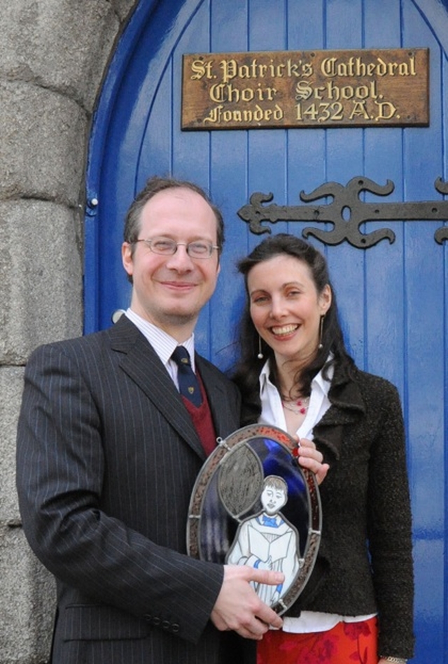 Former Organist and Master of Choristers in St Patrick's Cathedral Choir School Peter Barley and his wife Christine with a presentation made to him by members of the Schools' Parent Teacher Association.