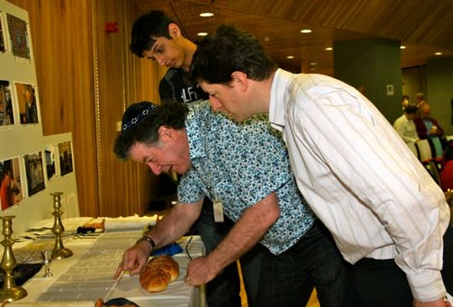 Yanky Fachler of the Dublin Jewish Progressive Community shows some Jewish scrolls to Yusef Syed and Damien Jackson at the Dublin City Interfaith Forum seminar in the Wood Quay Venue. 