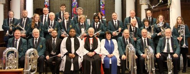 Archbishop Michael Jackson, the Revd Obinna Ulogwara and Gillian Dean with the St George’s Brass Band in St George and St Thomas’s Church, Cathal Brugha Street, for the International Carol Service. 