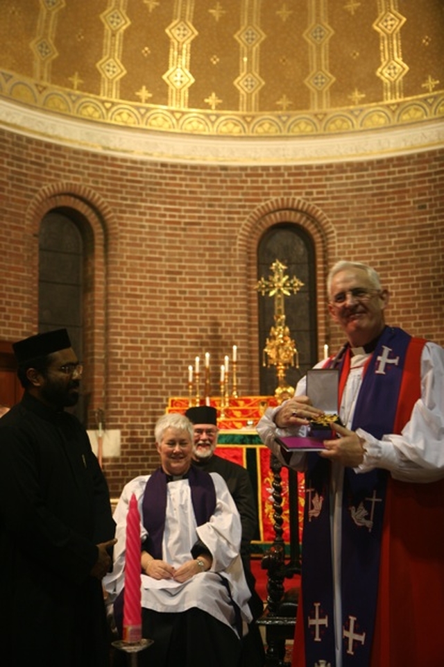 The Archbishop of Dublin, the Most Revd Dr John Neill receives a gift of a new Pectoral Cross from Fr Koshy Vaidyan of the Indian Orthodox Church at their Ecumenical Service in St George and St Thomas. The Church of St George and St Thomas is shared between the Church of Ireland and the Indian Orthodox Church. In the background are the Revd Canon Katharine Poulton and Fr Godfrey O'Donnell of the Romanian Orthodox Church.
