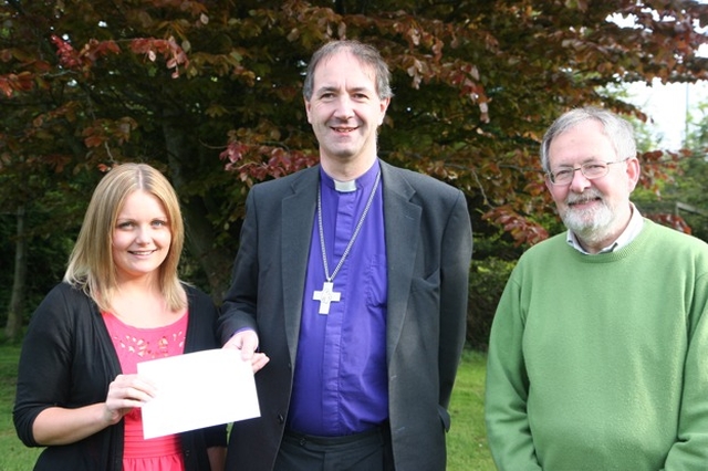 Pictured is ordinand Nicola Halford presenting a cheque to the Rt Revd Michael Burrows, Bishop of Cashel and Ossory for Bishops' Appeal, the proceeds of the ordinand's 'wax, shave, try or dye' fundraising effort. Also pictured is Martin O'Connor of Bishops' Appeal.