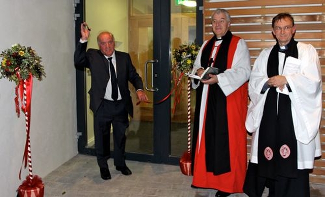 Organist John Keogh cutting the ribbon at St Saviour’s Parish Hall, Arklow, while Archbishop Michael Jackson and the Rector, Canon Nigel Sherwood look on. 