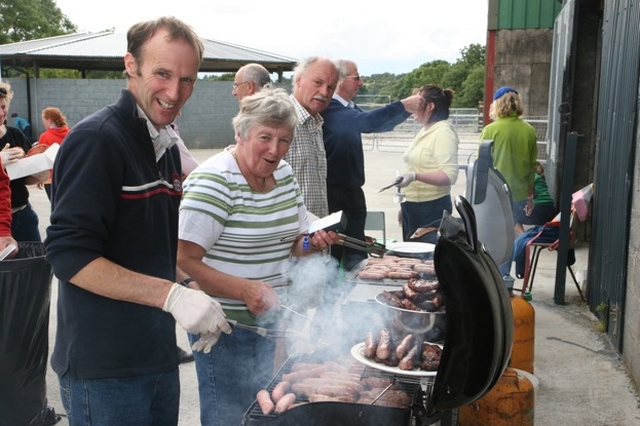 Tending the BBQ. Robin Moody and Heather Moody producing the Haute Cuisine at the annual Donard and Dunlavin Parish Ride out and BBQ in Moat Farm, Donard.