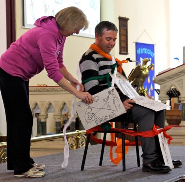 The Revd Isaac Delamere (Timolin) is bound by chains of poverty to illustrate the Revd Olive Donohoe’s (Athy) sermon at the West Glendalough Children’s Choral Festival in St Michael’s Church, Athy. 