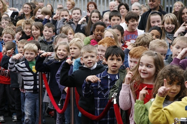 Pupils of Springdale National School show their delight as they celebrate the official opening of their new school building.