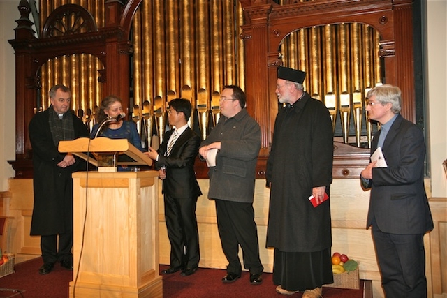 Church leaders gather to give their final blessings at the conclusion of the Advent Walk of Light in the Adelaide Road Presbyterian Church.