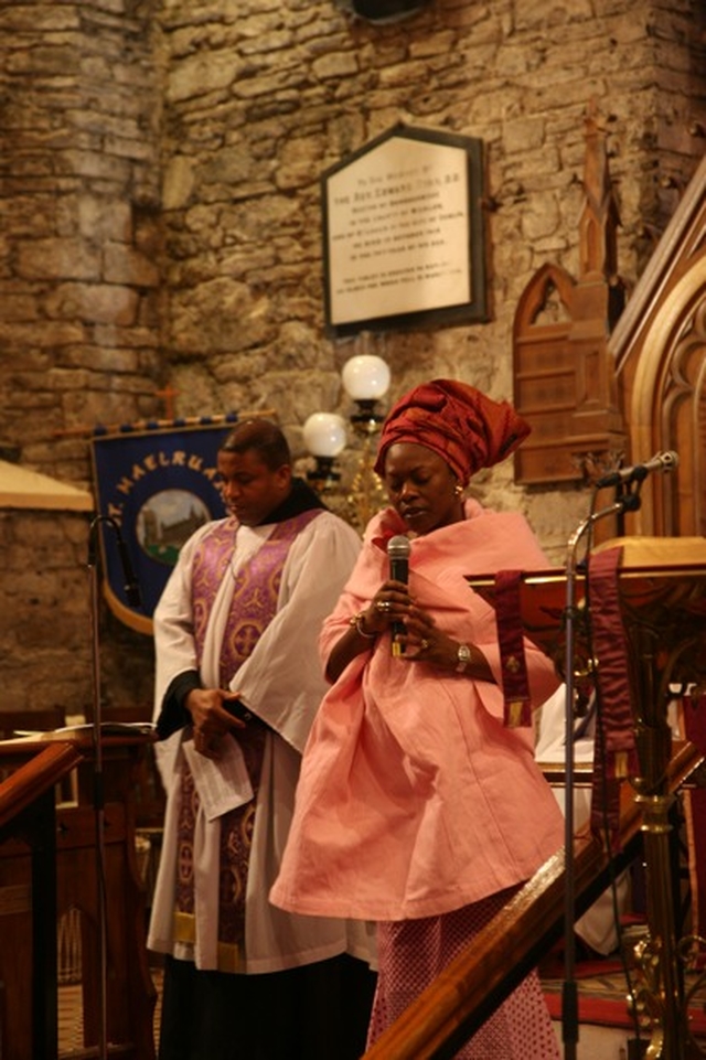 Ms Rom Olusa leads the prayers at the Discovery Advent Service in St Maelruain's Church, Tallaght. Also pictured in the background is the Diocesan Chaplain to the International Community, the Revd Obinna Ulogwara.