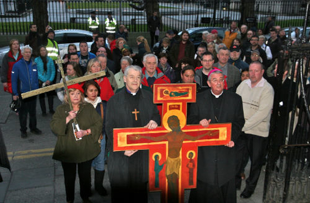 The Archbishops prepare to carry the Taizé cross up the steps of St Mary’s Pro Cathedral s they reach the end of their historic journey from Christ Church Cathedral.