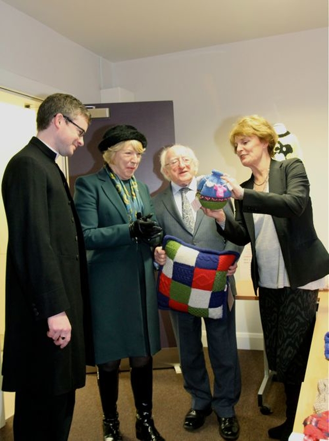 The President and his wife Sabina were presented with products made by the Sheep Thrills knitting group which meets weekly in the centre. They are pictured with the Rector of Holy Trinity, the Revd Niall Sloane and Sheep Thrills coordinator, Joan Millar, at the official opening of the refurbished centre. 