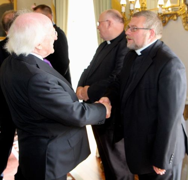 The Revd David Oxley is greeted by President Michael D Higgins at Áras an Uachtaráin during the visit of Cumann Gaelach na hEaglaise. 