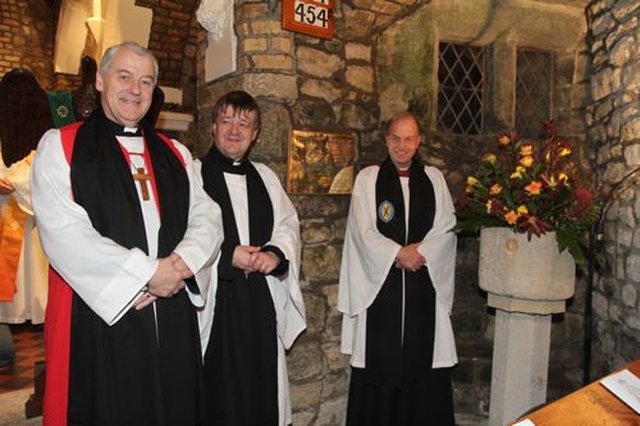 Archbishop Michael Jackson, the Revd Norman Gamble and the Revd Andrew Studdert Kennedy at the plaque marking the building of the Victorian aisle of St Doulagh’s Church. 