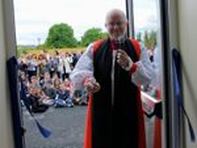 The Archbishop of Armagh, the Most Revd Dr Richard Clarke, cuts the ribbon of the extension of Drumcondra National School. 