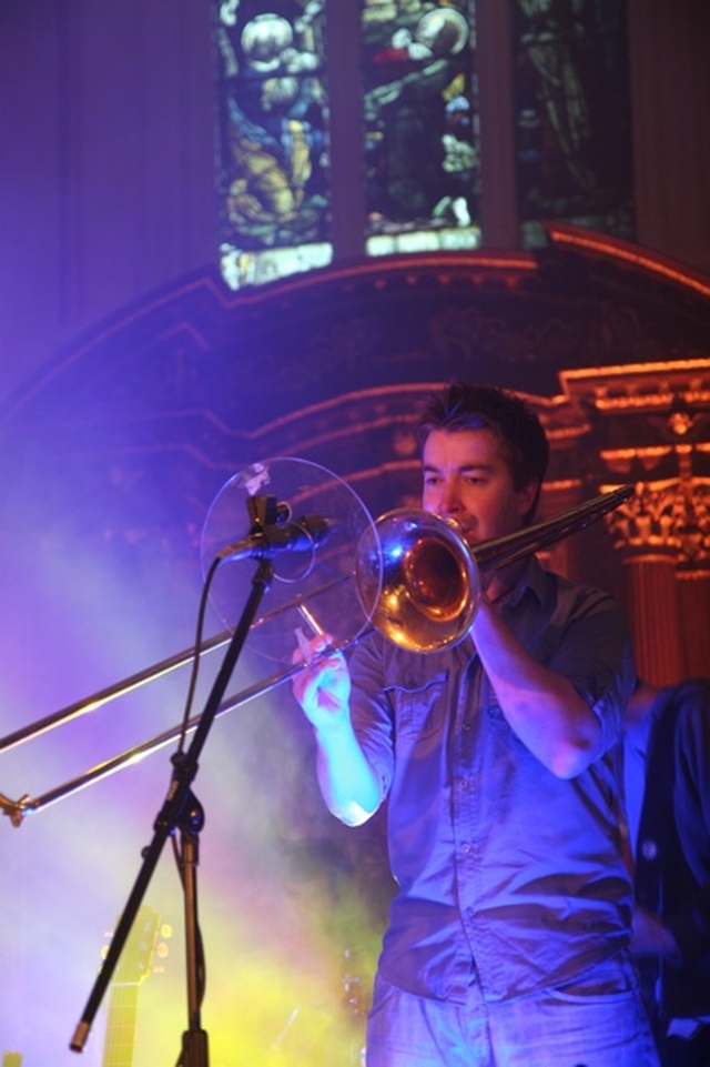 A member of the Rend Collective playing the trombone at 3 Rock's Reach Beyond Diocesan Youth Service in St Ann's, Dawson Street, Dublin.
