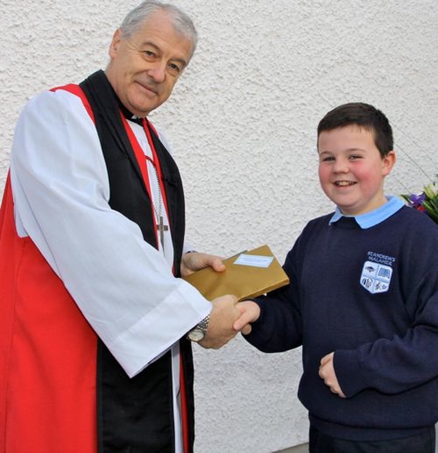 Archbishop Michael Jackson was presented with a memento of his visit to St Andrew’s National School, Malahide, for the opening of the school’s new extension. 