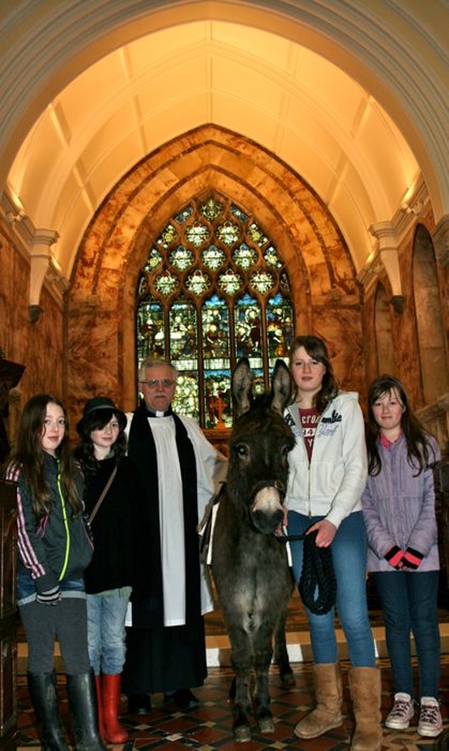 Howard the donkey is welcomed to Killiskey Parish Church by associate vicar, the Revd Ken Rue and parishioners. 