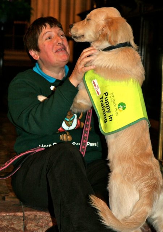 Organiser of the annual Peata Carol Service in Christ Church Cathedral meets Ushi, a puppy in training, following the service. 