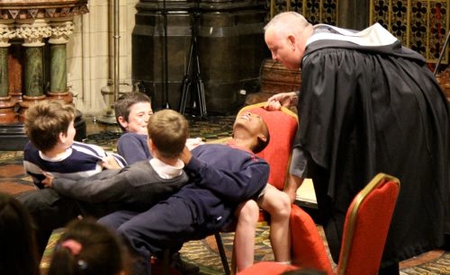 The Revd Nigel Mackey and four volunteers engaged in a trust exercise during the Diocesan Schools Service in Christ Church Cathedral. 