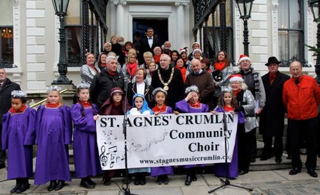 The organisers and readers at the Community Carol Singing with the choir on the steps of the Mansion House.