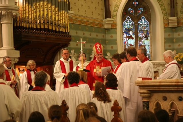 The Archbishop of Dublin, the Most Revd Dr John Neill presents the Revd Suzanne Harris with a bible at her ordination to the priesthood in St Philips and St James' Church, Booterstown.