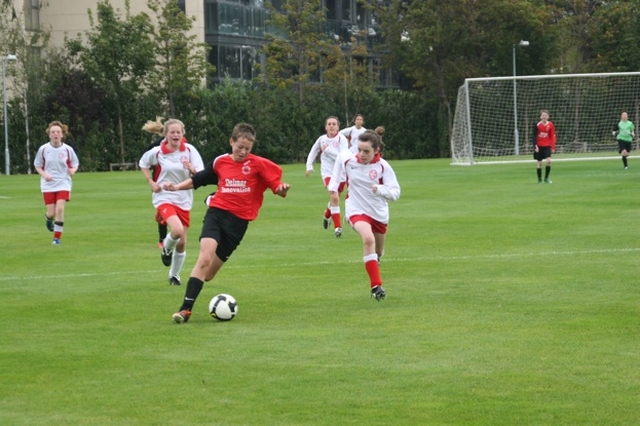 Pictured is action from a Soccer match between Alexandra College  under 14s (red and white) and Cherry Orchard Boys u12s (black and red). The match was part of a programme of events to mark the official opening of two new pitches and one all purpose court in Alexandra College. Cherry Orchard won the match 4-2.