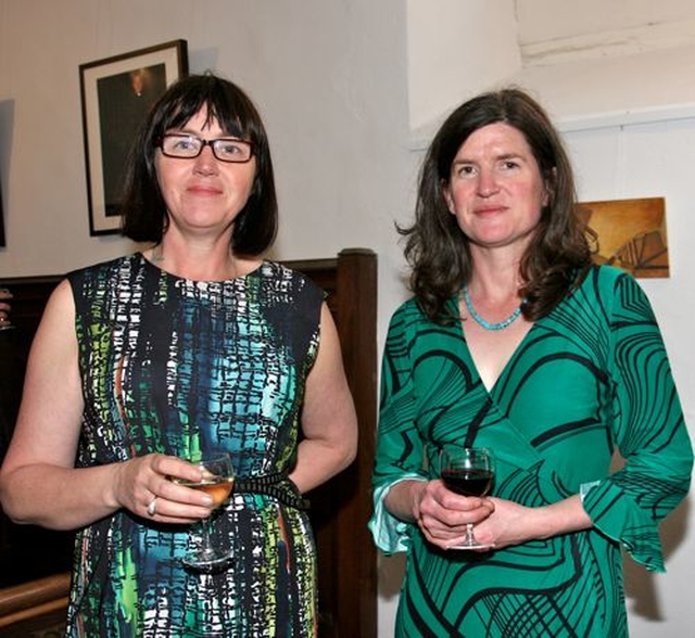 Photographer Mella Travers and painter Maeve McCarthy at the opening of their exhibition, ‘Reflections’ – the first to be held in the new community art gallery in St Michan’s Church. Their work can be seen behind them. 