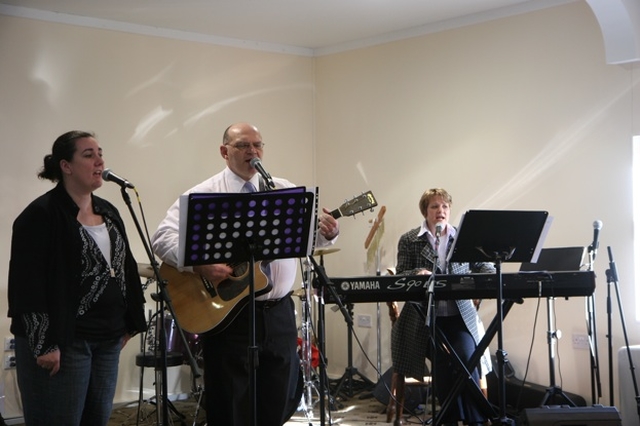 Worship leaders in Redcross Pamela Dix, Richard Redmond and Miriam O'Regan and Cormac Ó Ceallaigh (on drums - partly obscured) at the dedication of Trinity hall worship centre and the commissioning of a new youth pastor in Redcross.