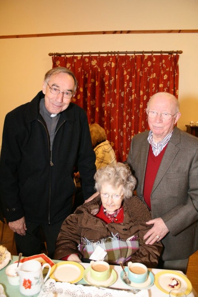 The Revd Harry Lew, Sylvia and Willie Clarke at the reception following the Mageough Chapel Carol Service