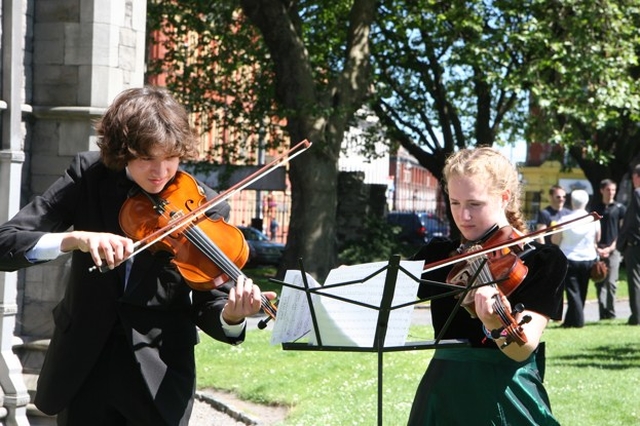Members of the Langley Youth Orchestra in an impromptu outdoor rehearsal in Christ Church Cathedral before their Concert inside. 