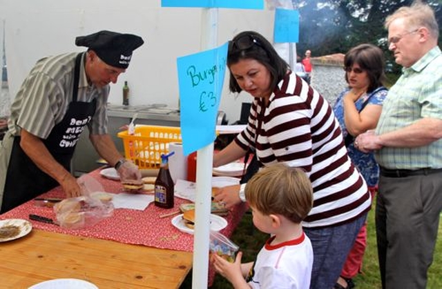 Ernest Henderson dressed for the occasion as he takes charge of the burger stall at Donoughmore Fete and Sports Day. 