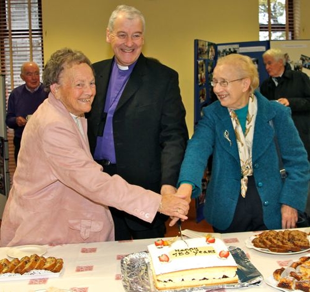 Rosemary Knight, Archbishop Michael Jackson and Catherine McGuinness cut the cake marking the 150th anniversary of Kill O’ the Grange parish church. 
