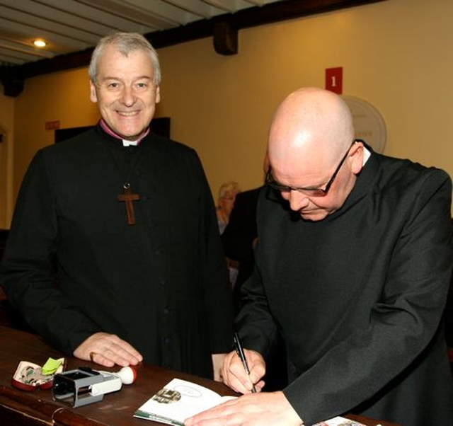 Archbishop Michael Jackson gets his Camino passport stamped and signed in St Ann’s, Dawson Street, by verger, Fred Deane. The pilgrim walk is part of the International Eucharistic Congress. 