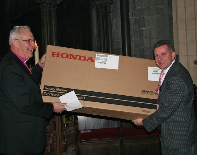 Diocesan Secretary Scott Hayes presenting Archbishop Neill with the gift of a lawn mower at a special presentation ceremony in Christ Church Cathedral following the Eucharist to mark his retirement as Archbishop of Dublin and Glendalough.