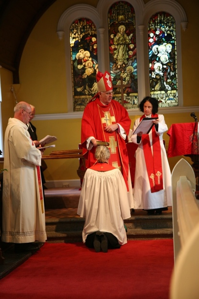 The Archbishop of Dublin and Bishop of Glendalough, the Most Revd Dr John Neill places a bible on the head of the Revd Terry Alcock during her ordination to the priesthood in St James' Church, Castledermot. Also pictured (left) is the Archdeacon of Glendalough, the Venerable Ricky Rountree and the Archbishop's Chaplain, the Revd Patricia Taylor (right).